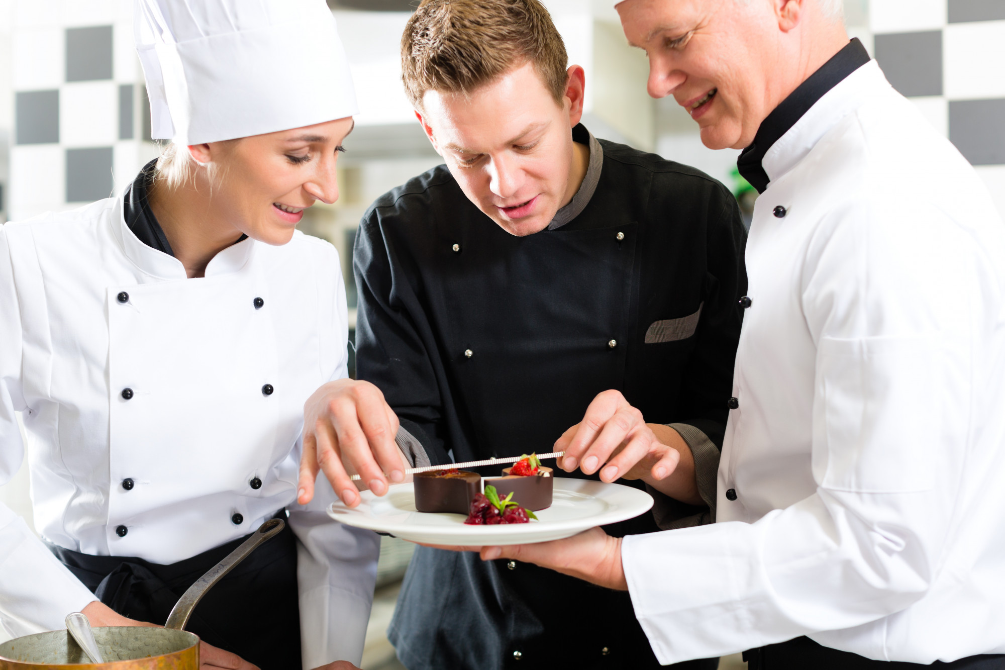 Chef guiding students through plating